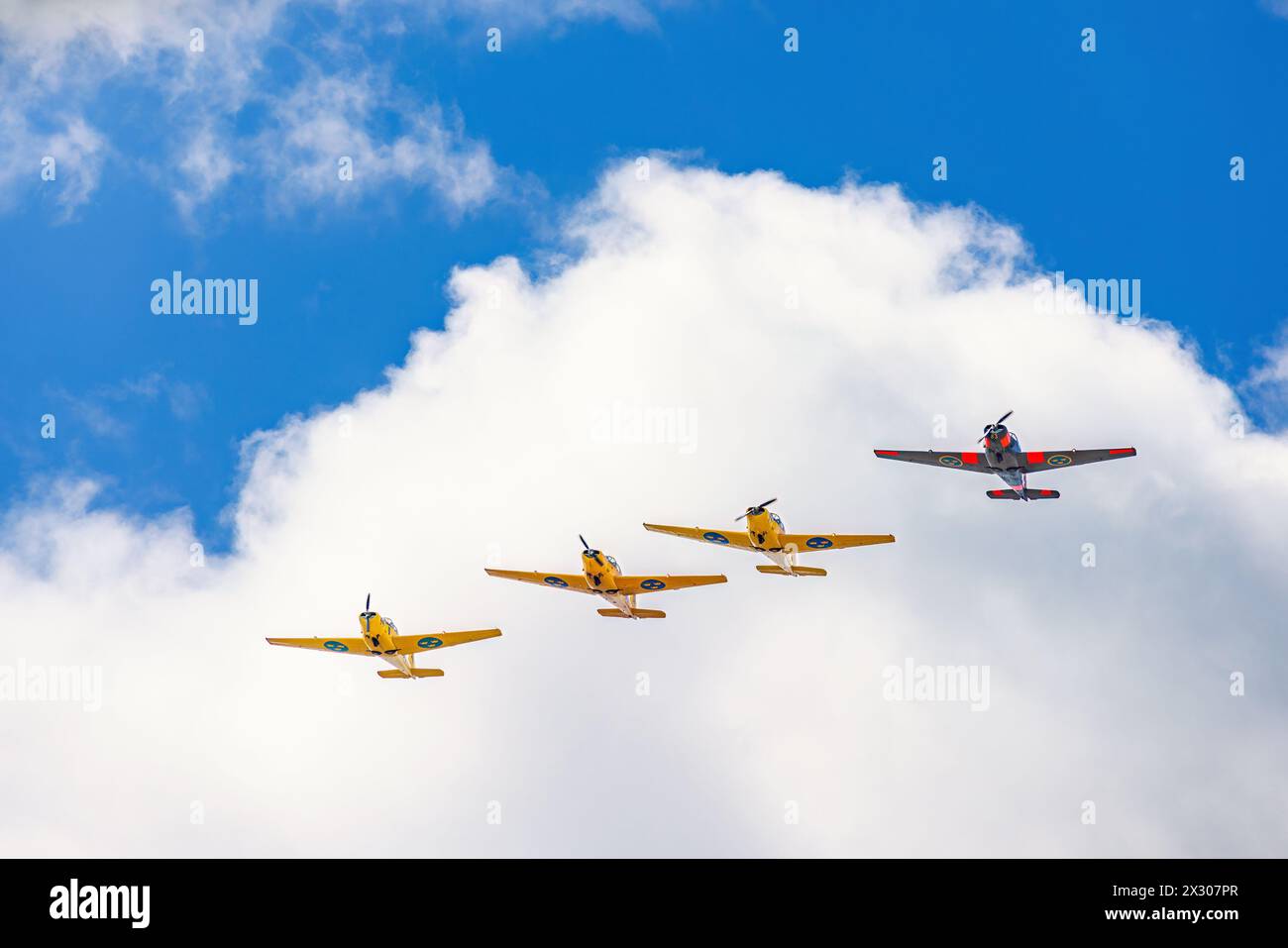 Propeller planes flying in formation in the sky Stock Photo