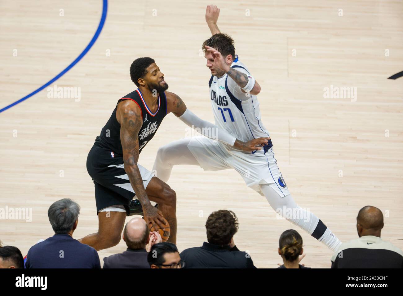 Los Angeles, United States. 23rd Apr, 2024. Los Angeles Clippers' Paul George (L) drives against Dallas Mavericks' Luka Doncic (R) during an NBA basketball playoffs round one game 2 at Crypto.com Arena. Final score: Mavericks 96:93 Clippers Credit: SOPA Images Limited/Alamy Live News Stock Photo