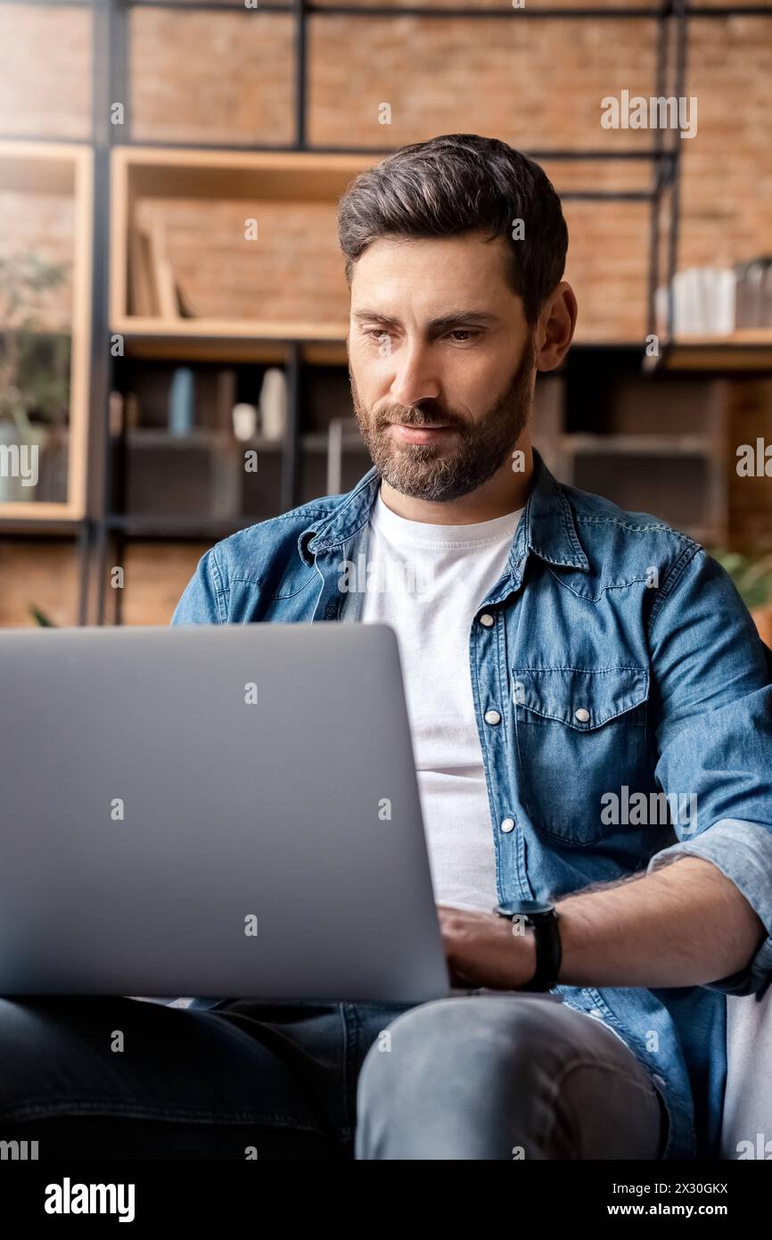 Handsome caucasian man videoconferencing chatting online using laptop computer Stock Photo
