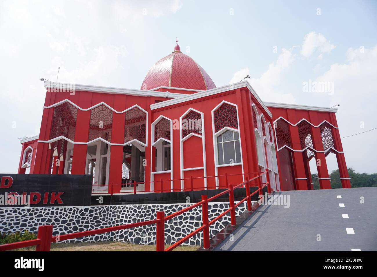 The Moekhlas Sidik Mosque is often referred to as the red mosque in Pandaan, Indonesia Stock Photo