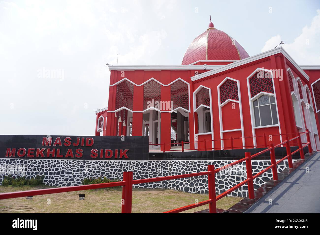 The Moekhlas Sidik Mosque is often referred to as the red mosque in Pandaan, Indonesia Stock Photo