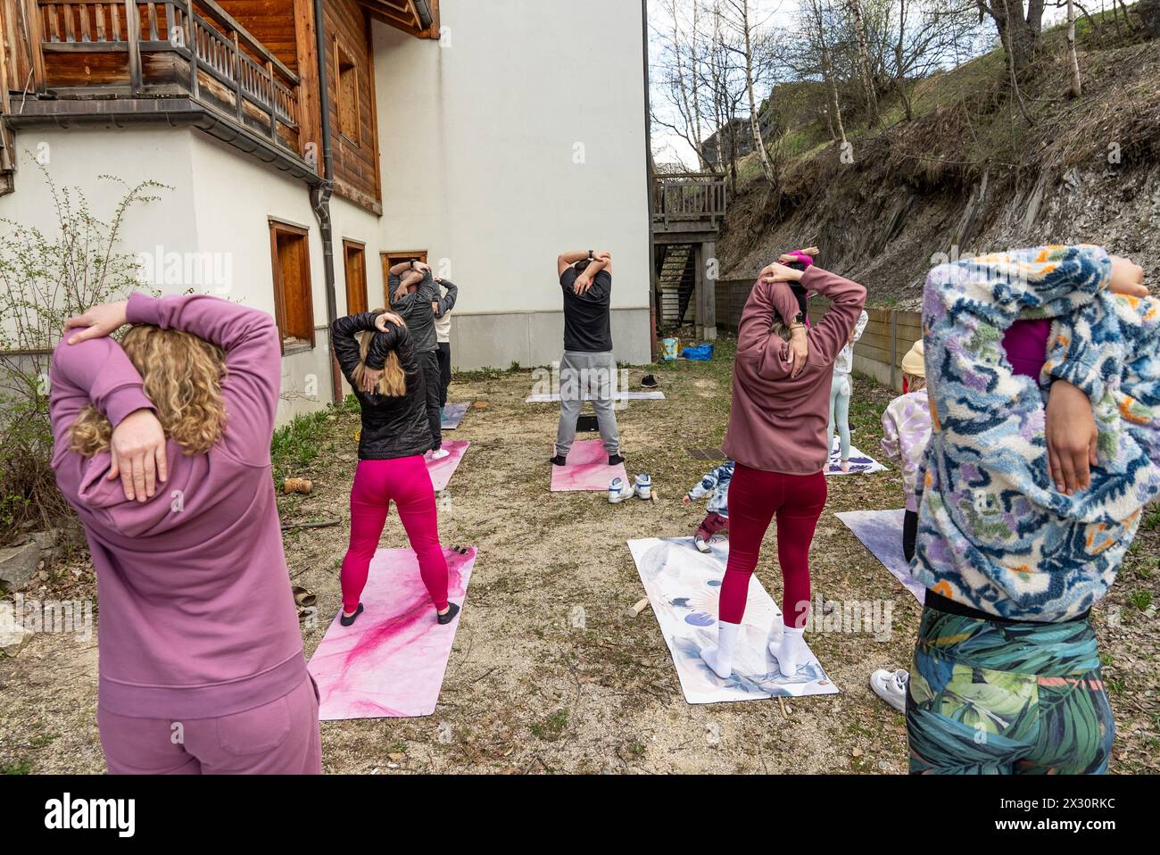 Mixed age group of people practicing yoga outside. Active people practicing yoga outside. Stock Photo