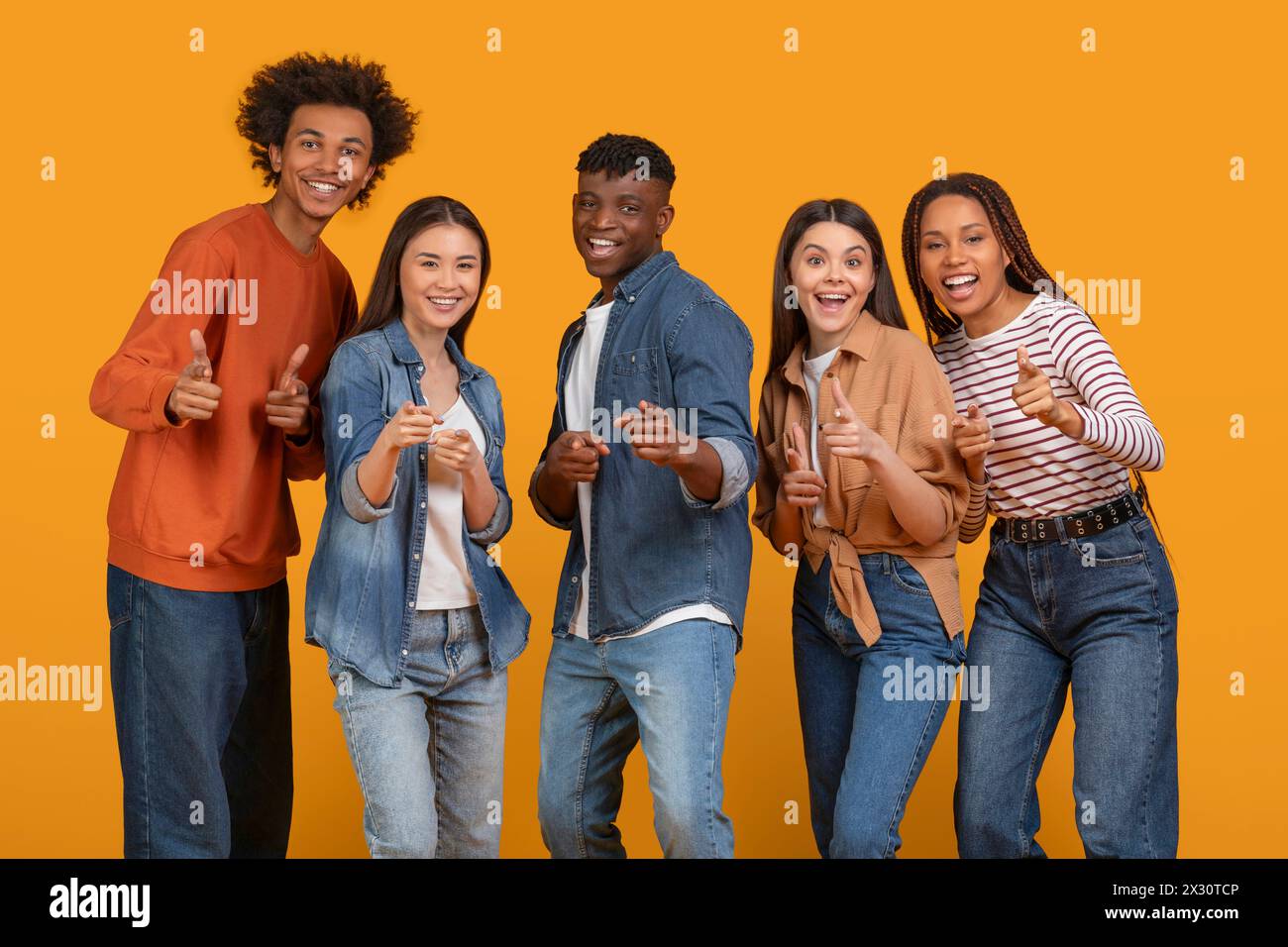 Thumbs up from a multiethnic young team Stock Photo