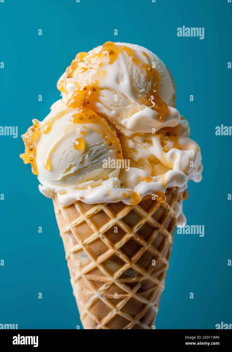 Two scoops of Vanilla ice cream on top ice cream cone blue background ...