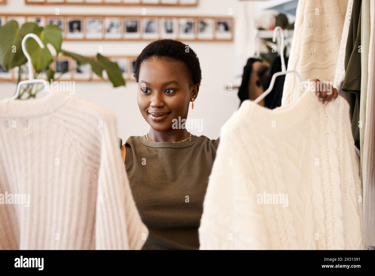Retail, shopping and black woman in store, customer and choice in show room or boutique. Purchase, fabric and thrift clothing for eco friendly and Stock Photo