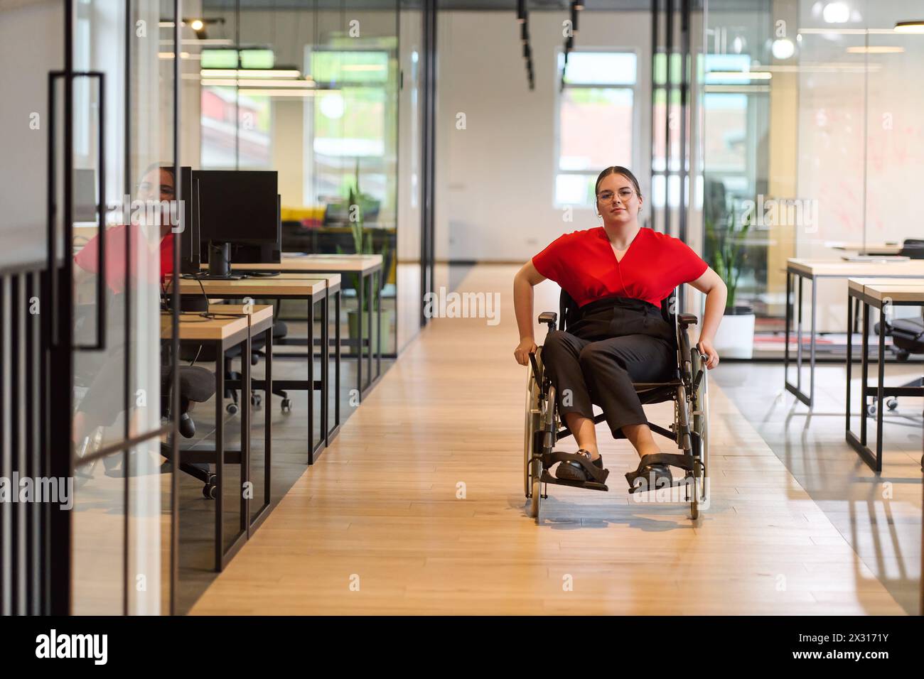 A modern young businesswoman in a wheelchair is surrounded by an ...