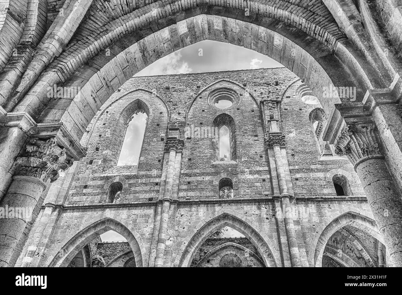 CHIUSDINO, ITALY - JUNE 22: Interior view of the iconic roofless Abbey of San Galgano, a Cistercian Monastery in the town of Chiusdino, province of Si Stock Photo