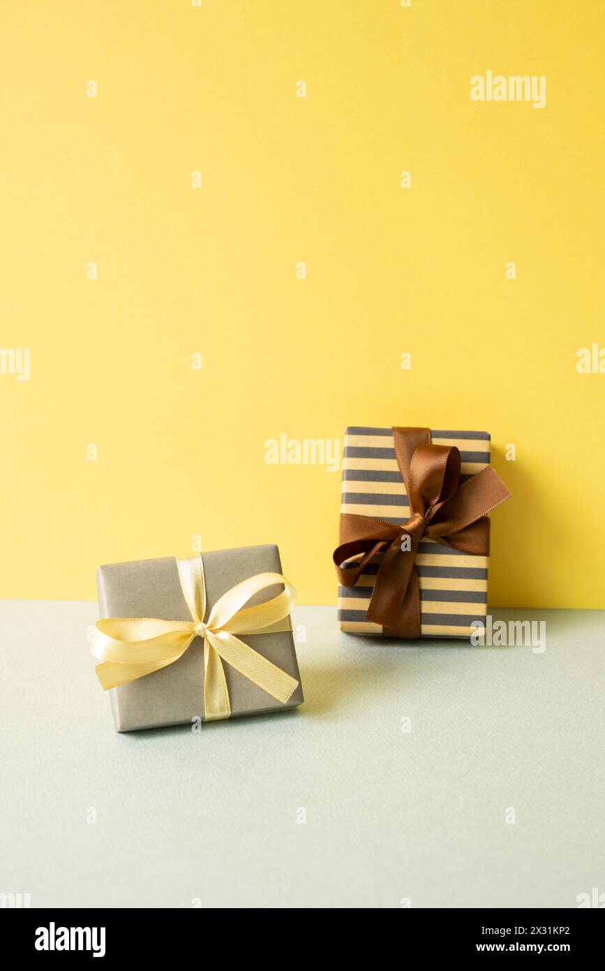 Gift boxes on gray table. yellow wall background Stock Photo