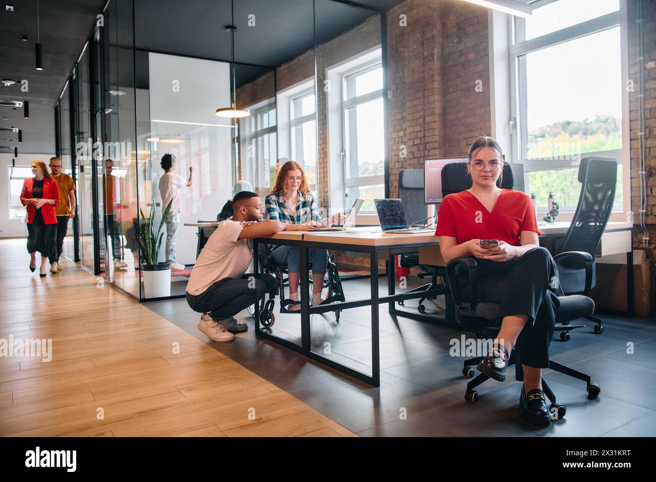 A diverse group of business professionals collaborates in a modern ...