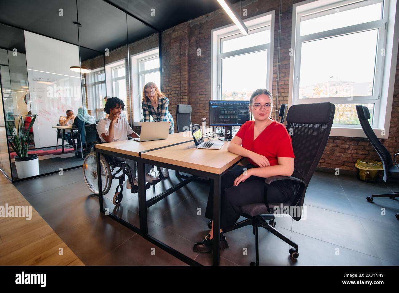 A diverse group of business professionals collaborates in a modern ...
