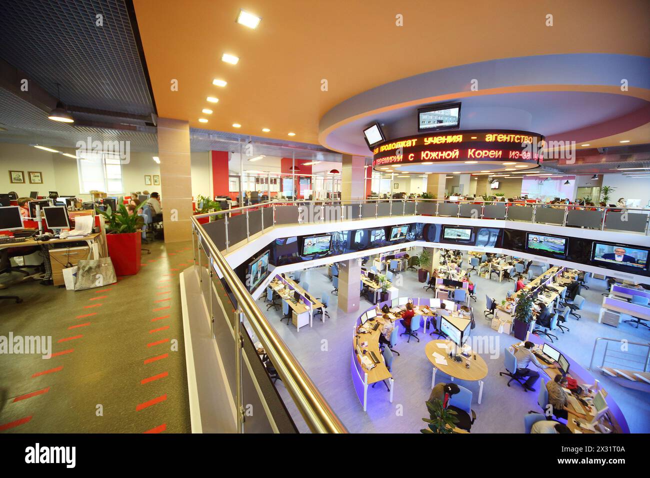 MOSCOW - MAR 5: People working in office news agency RIA Novosti with tables around on March 5, 2013 in Moscow, Russia. Stock Photo