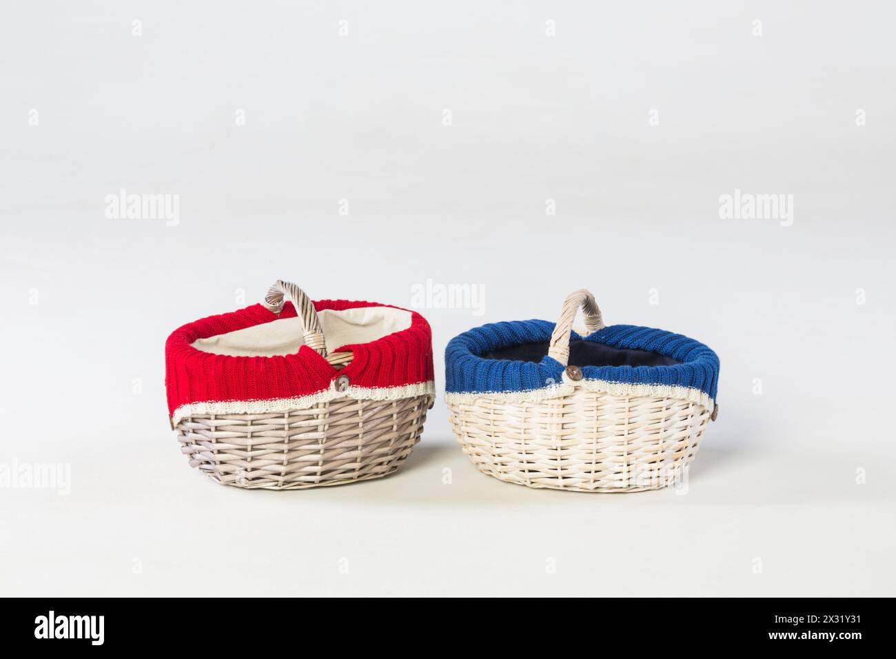 Two wicker baskets with knits inside in studio Stock Photo