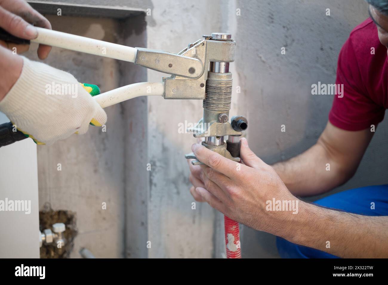 Workers swaged pipe heating system in the apartment Stock Photo
