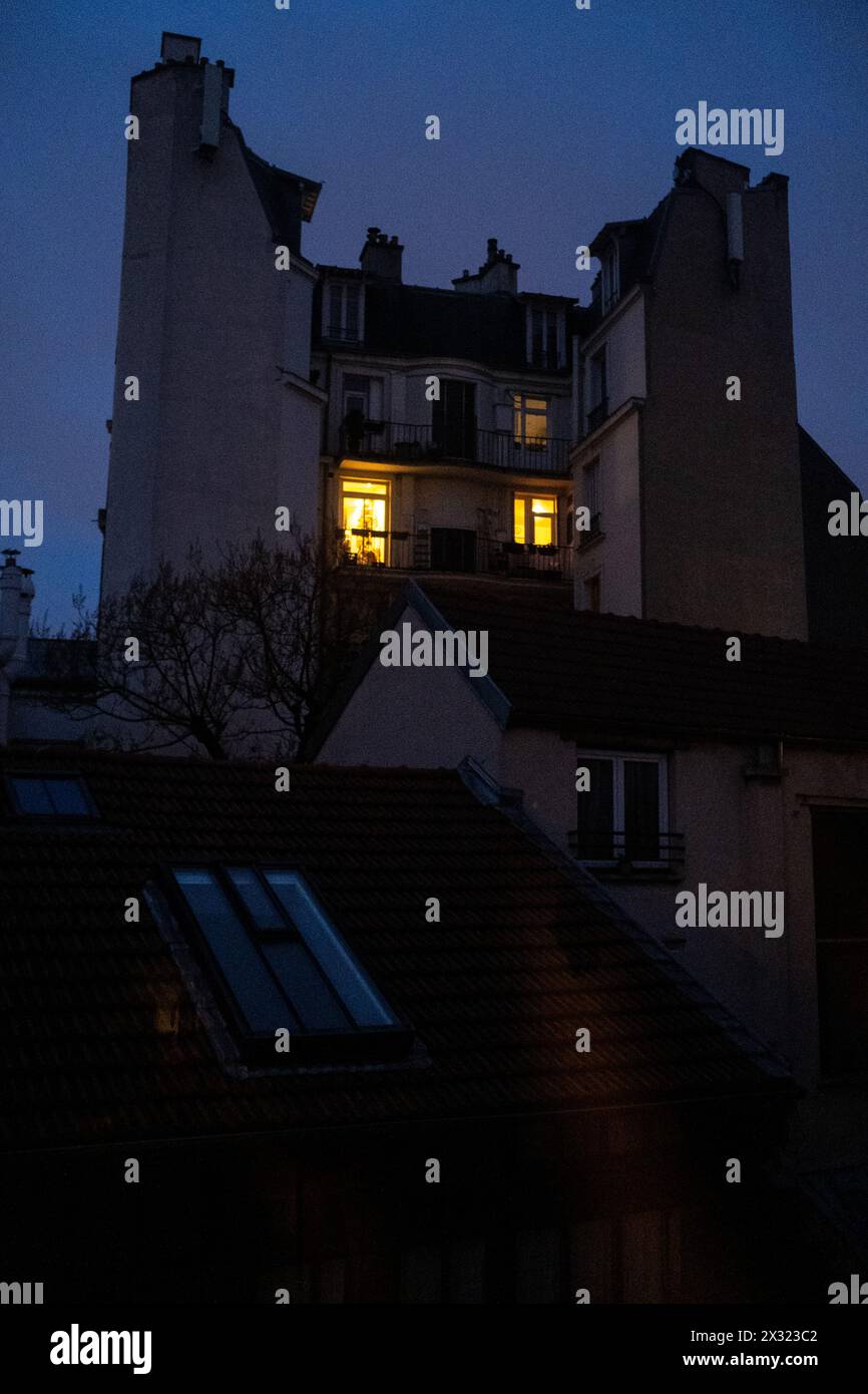 A Haussmann-style apartment building at dusk in the midst of the ...