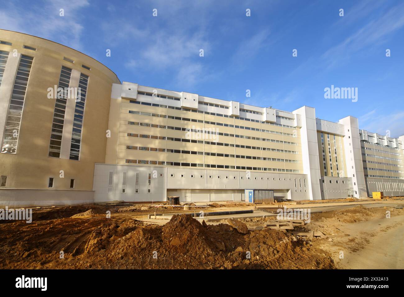 Long, large, multi-storey parking under construction at sunny day. Stock Photo
