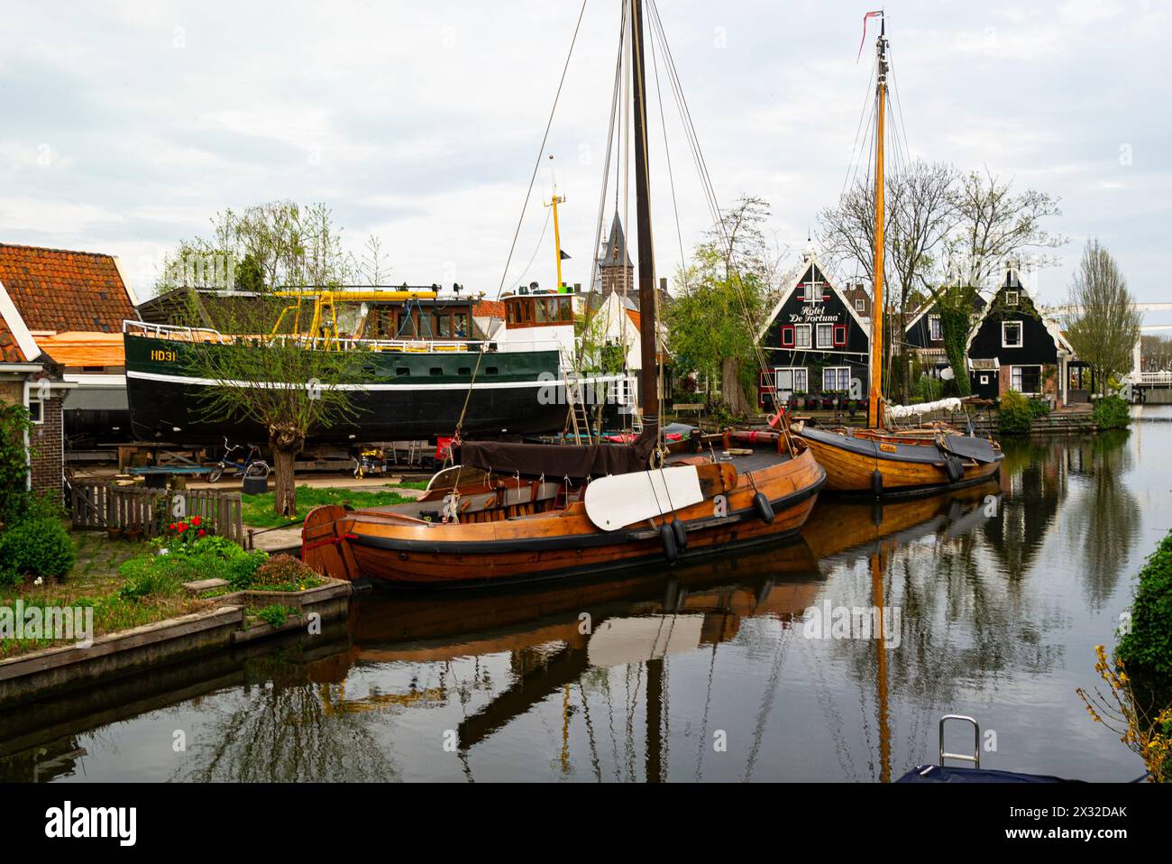 Wooden sail boats moored  on a canal in Edam town once a shipbuilding town world famous for its cheese. and located in the northern Dutch countryside Stock Photo