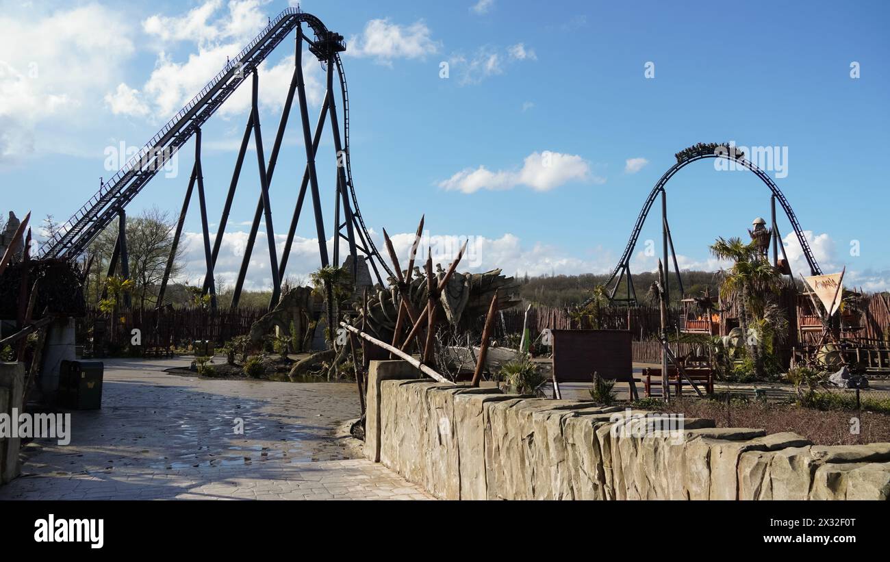 Rollercoaster 'Kondaa' with train on airtime hill and themed area in front of it, in the amusement park 'Walibi Belgium' Stock Photo