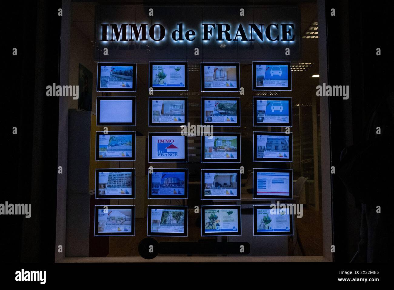 An Immo de France estate agency at dusk in the midst of the housing ...