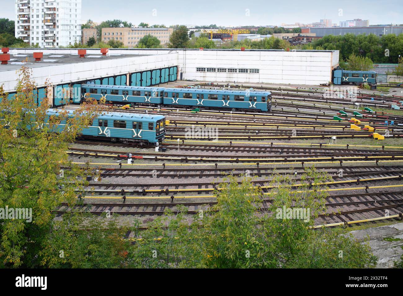 Two city underground trains leave the depot gates Stock Photo