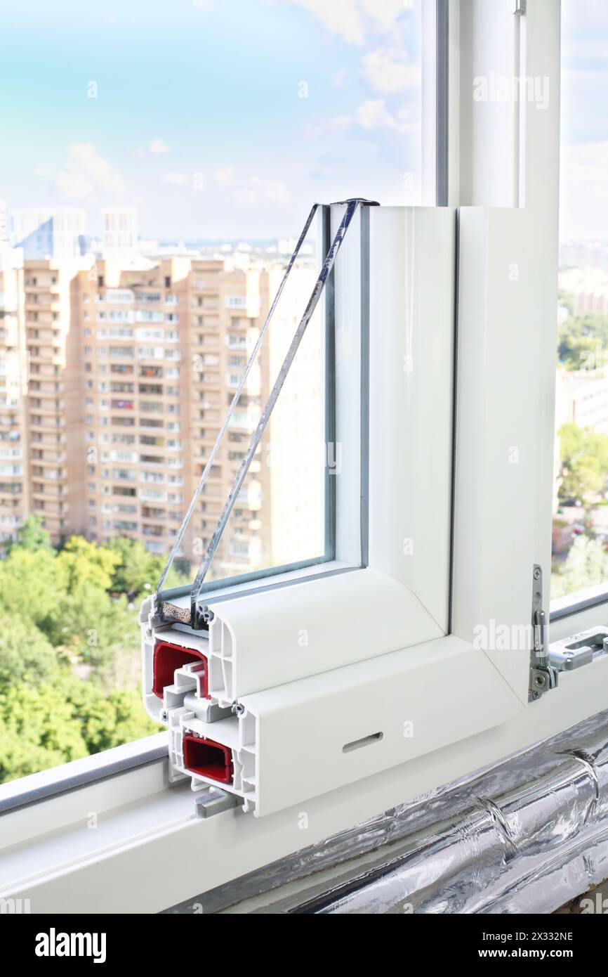 Sample PVC window in a window aperture with view of the park and ...
