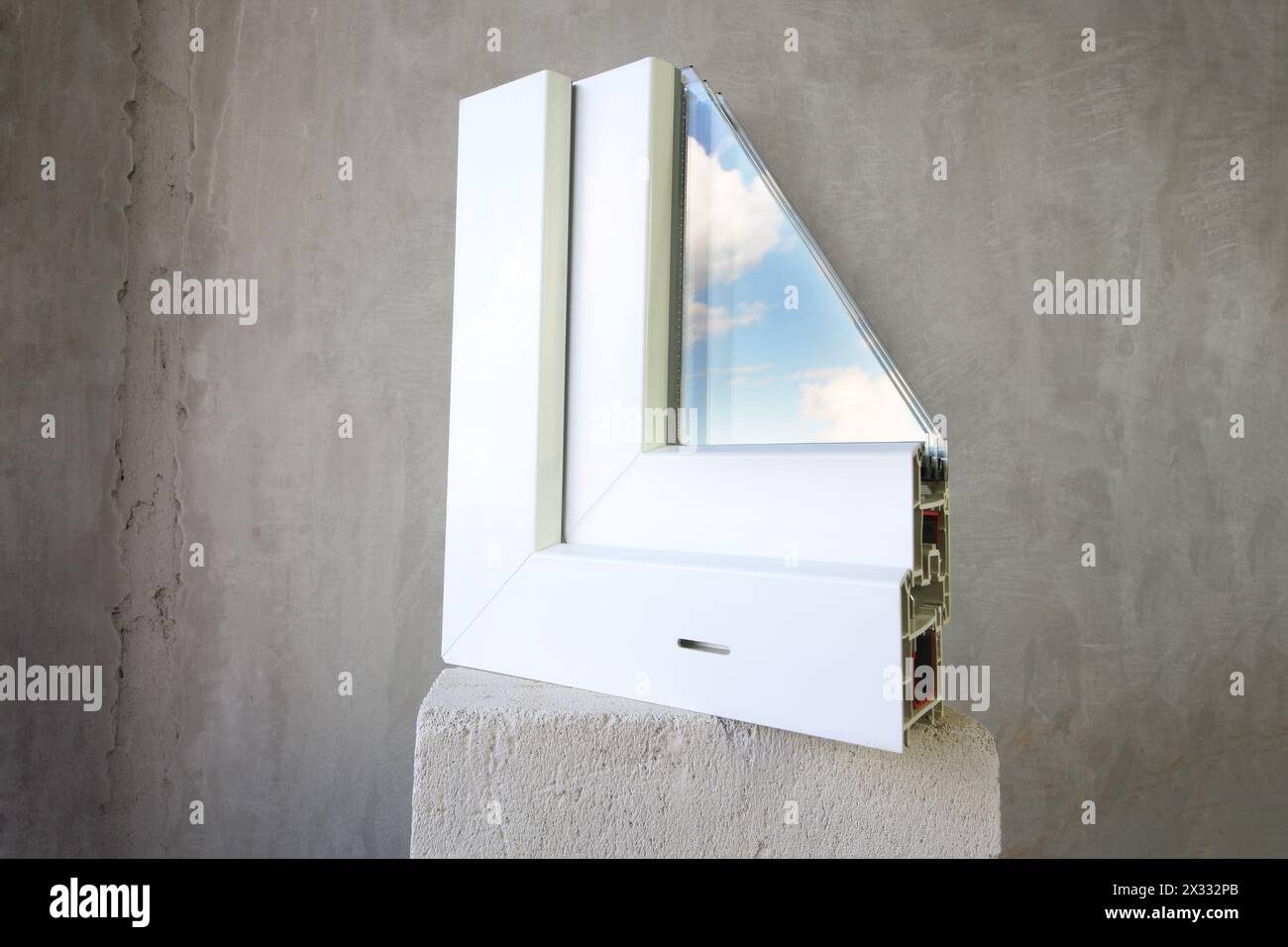 Sample PVC window stands on a concrete block, in the glass reflects the ...