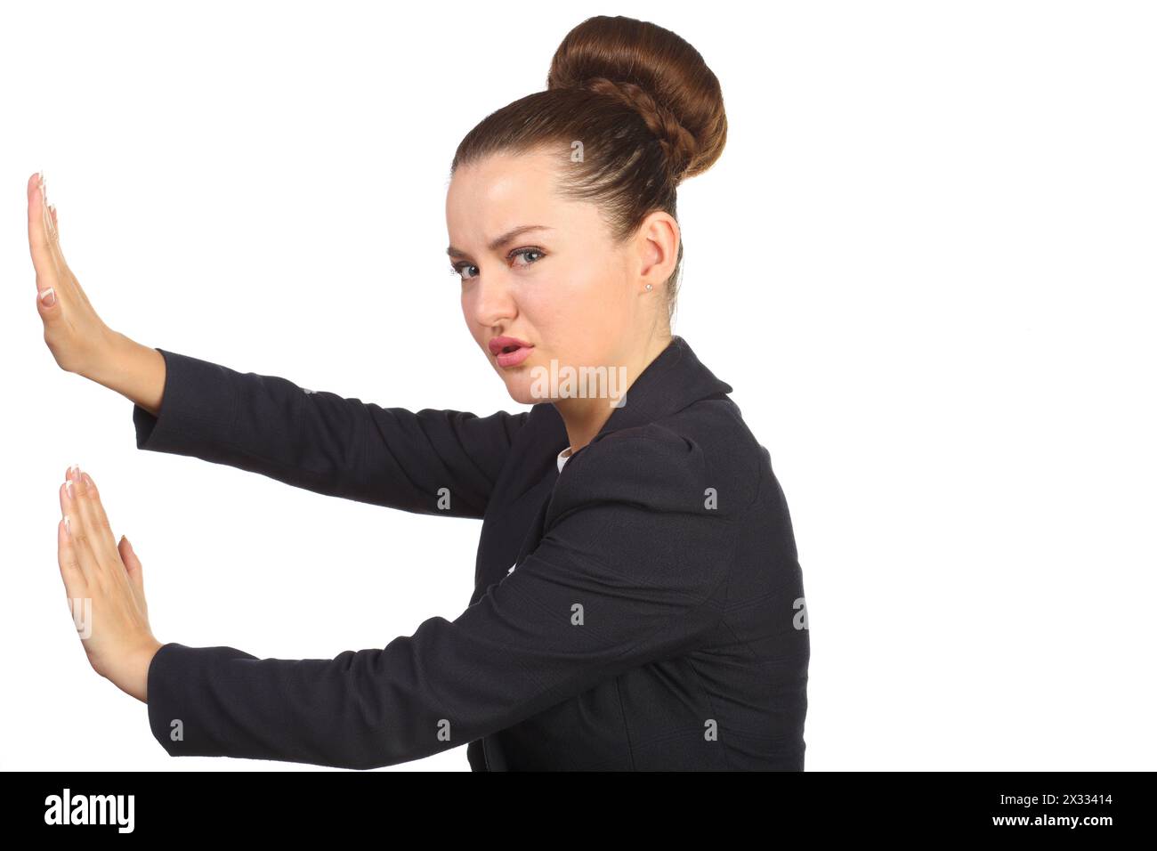 Beautiful girl with a chignon makes repulsive motion Stock Photo