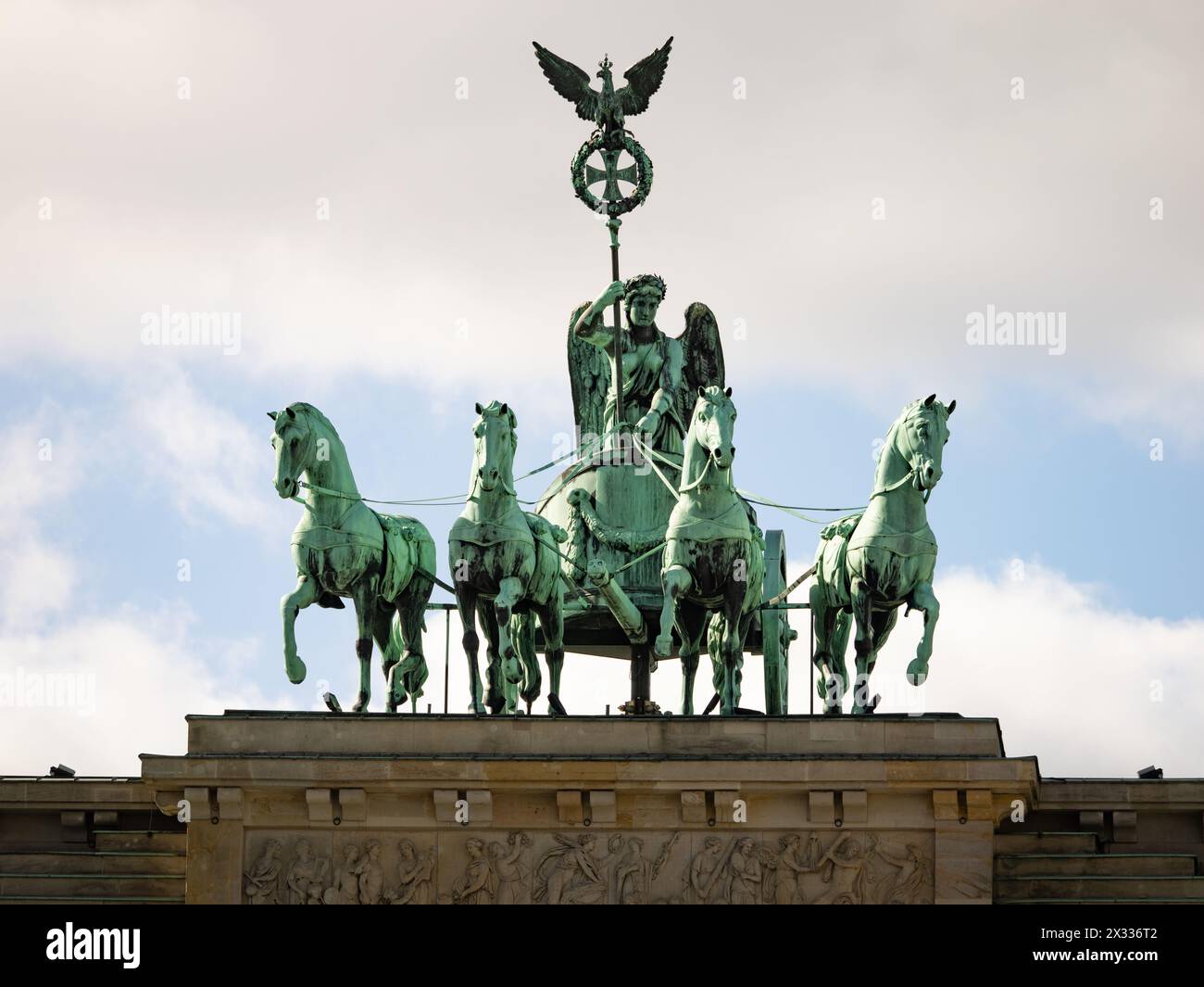 Quadriga sculpture group on the Brandenburger Tor building exterior in Berlin, Germany. The bronze art piece is made by Johann Gottfried Schadow. Stock Photo
