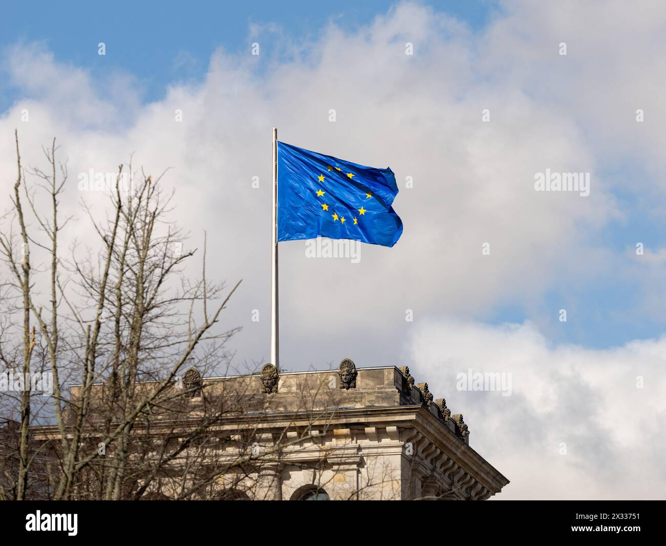 EU flag of the European Union on a governmental building exterior in Germany. Waving blue textile with yellow stars. Sign for democracy and politics. Stock Photo