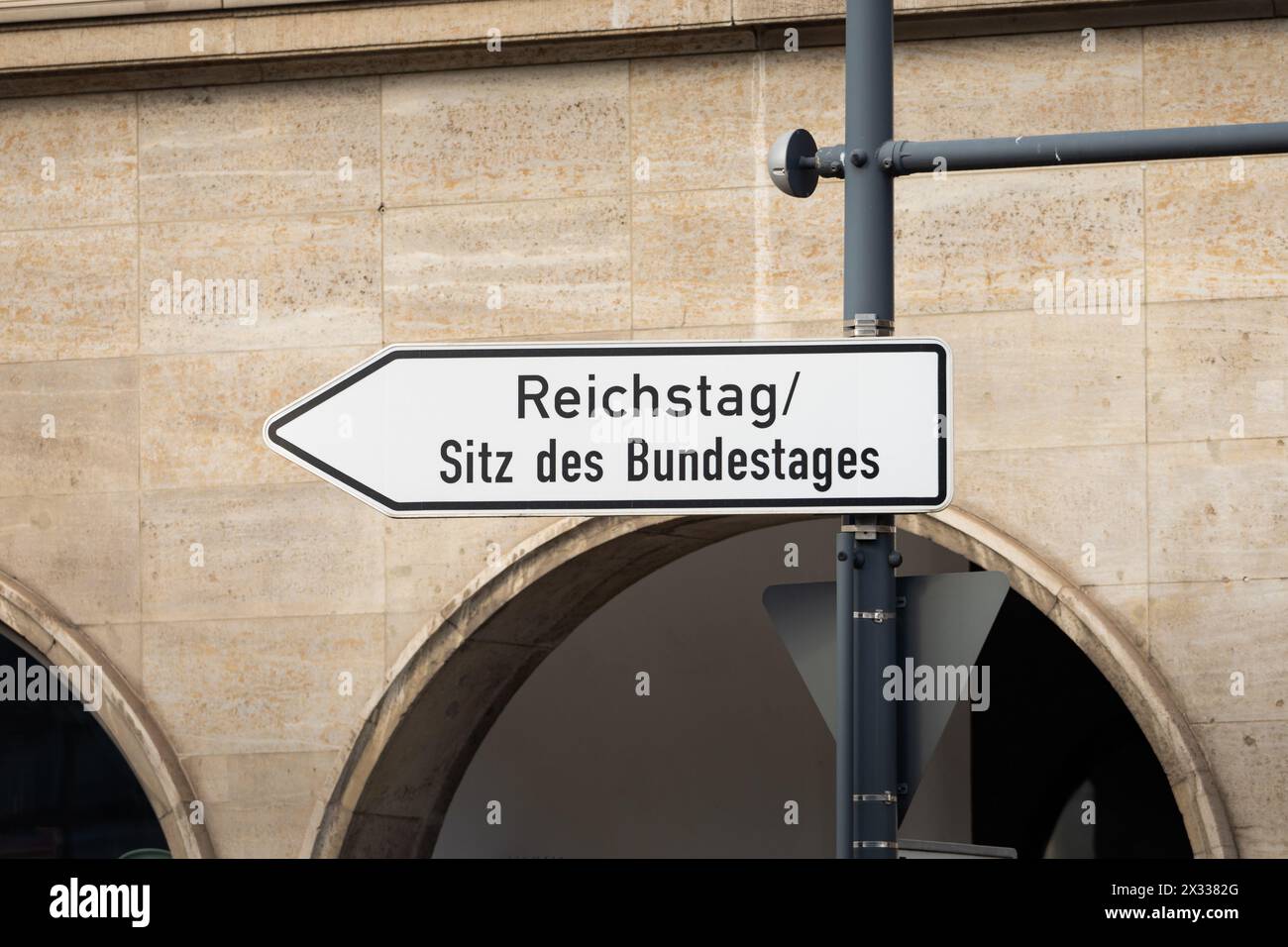 Reichstag and Sitz des Bundestages sign (German parliament). Arrow shape in the direction of the governmental buildings. Tourist attraction in Berlin. Stock Photo