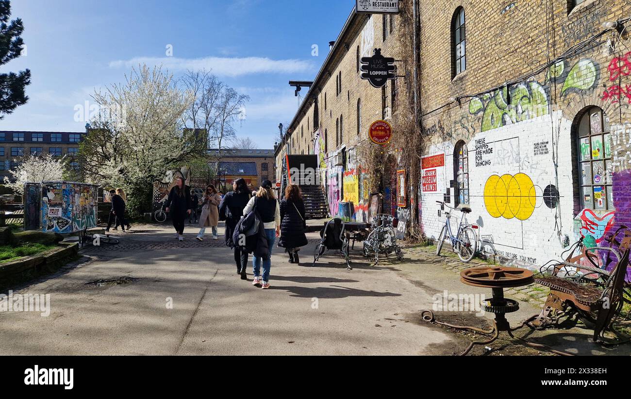 Copenhagen, Denmark - April 6, 2024: People walking in Freetown Christiania area. Stock Photo