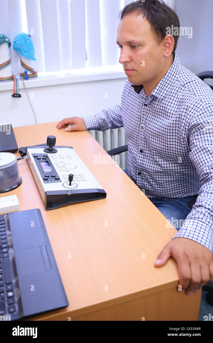 Man at the table with the control panel in the hospital Stock Photo