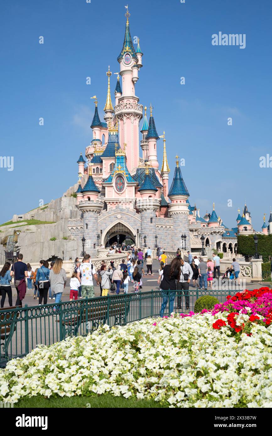 FRANCE, PARIS - SEP 10, 2014: Many tourists are walking near castle of Disneyland. Stock Photo