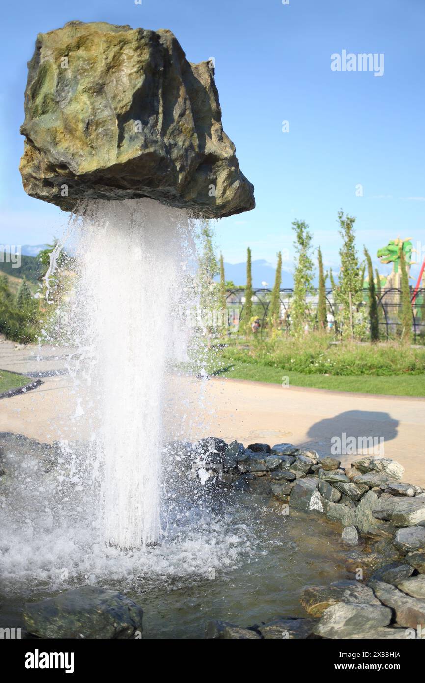 SOCHI, RUSSIA - JUL 28, 2014: Thematic Fountain Stone in Sochi Park. Streams of water supports huge boulders in weightlessness Stock Photo