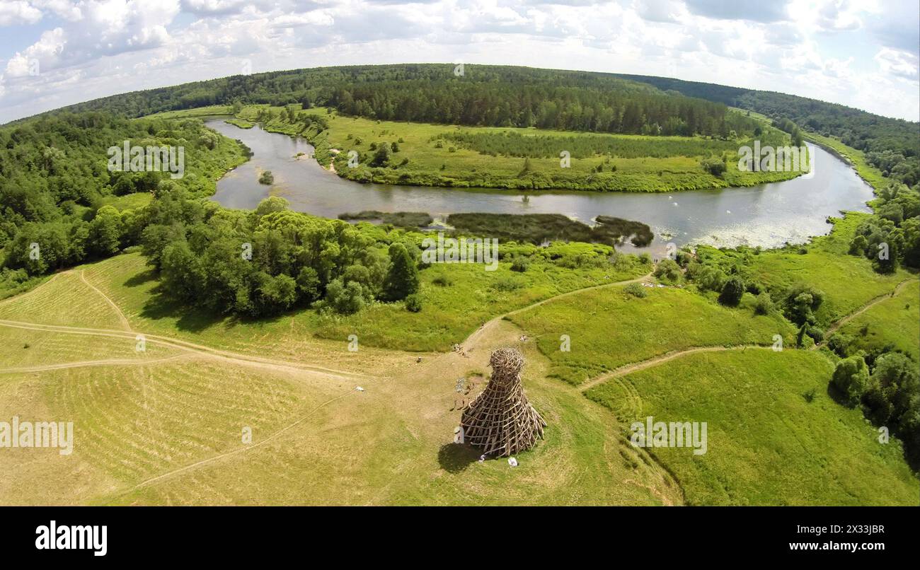 RUSSIA, NICOLA-LENIVETS - JUL 6, 2014: River shore with art object Lighthouse On Ugra in Wonderland Park during 9th Festival of landscape objects Arch Stock Photo