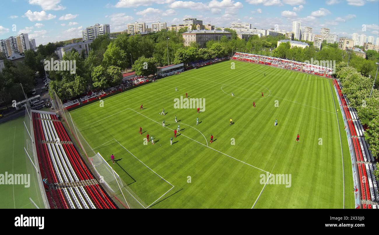 RUSSIA, BOGORODSKOE  - MAY 14, 2014: Soccer teams play on field of Spartakovec stadium named by N.P. Starostin during international competition. Aeria Stock Photo