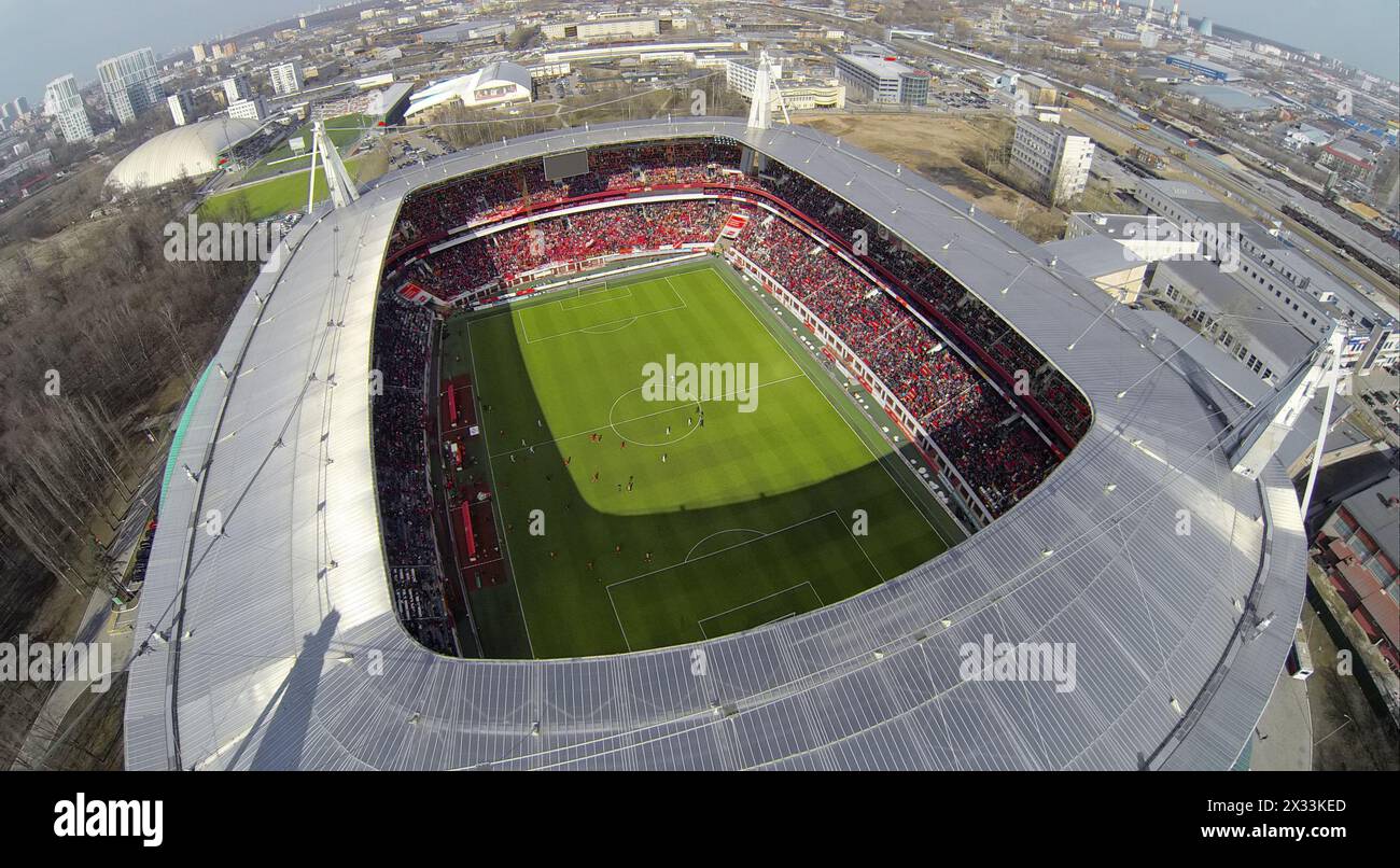 MOSCOW, RUSSIA - APR 28, 2014: People watch soccer game in Locomotive sports stadium at evening. Aerial view Stock Photo