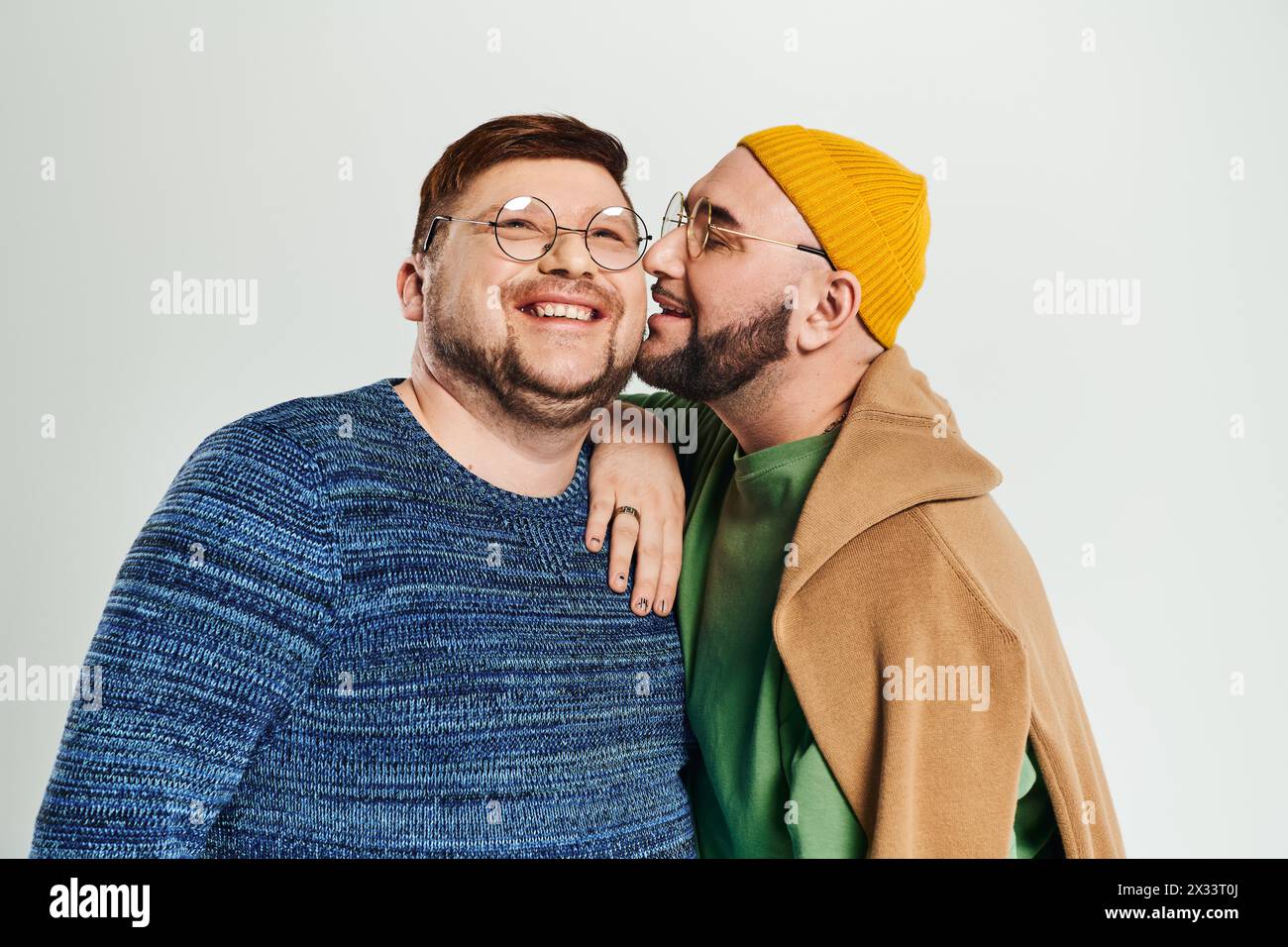 A loving duo of men standing beside each other. Stock Photo