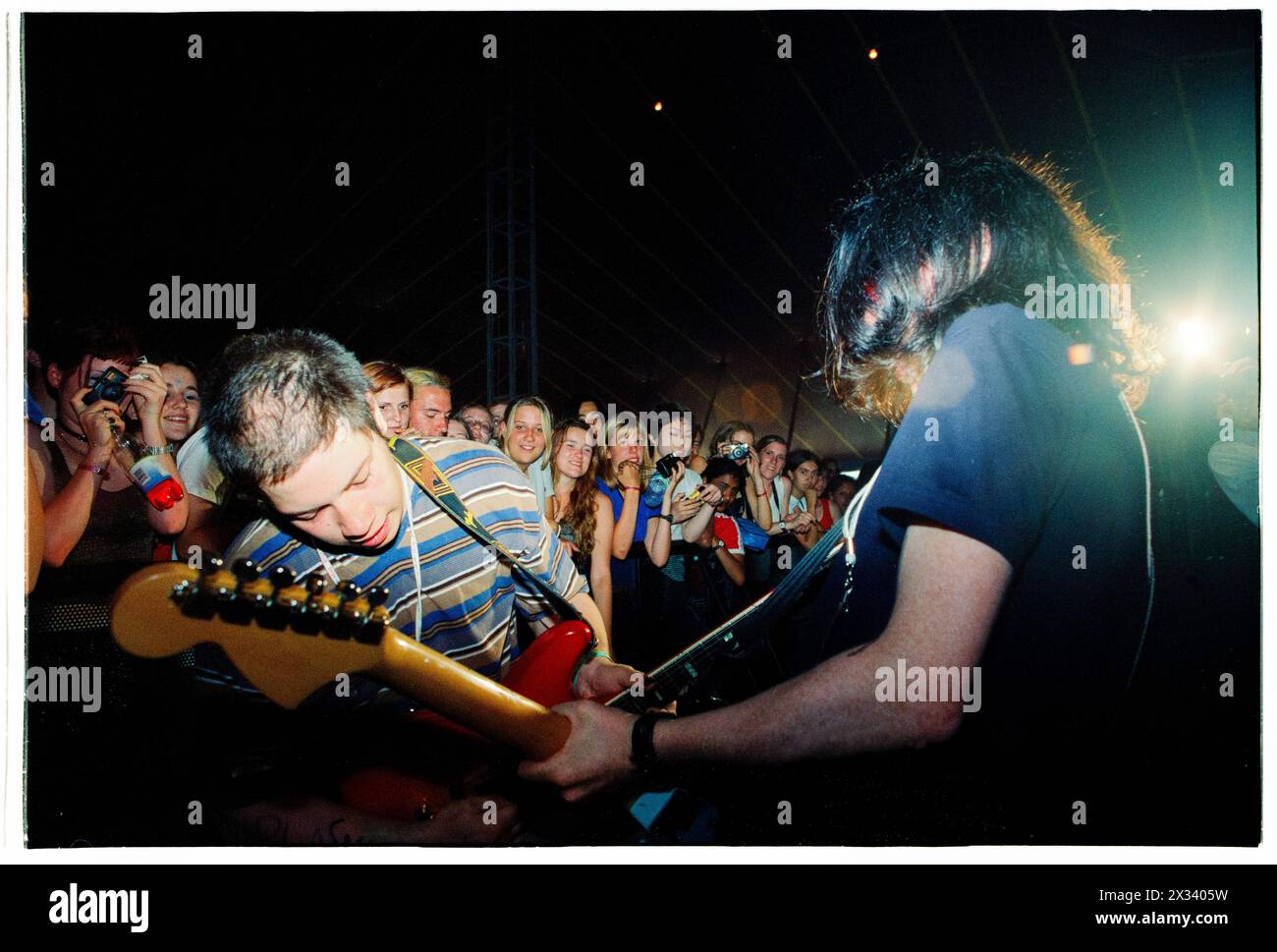 MOGWAI, EARLY CAREER, 1997 CONCERT: A young Stuart Braithwaite and John Cummings of Mogwai playing in front of the crowd barrier in the pit on the Melody Maker Stage at Reading Festival, Reading, UK on 24 August 1997. Photo: Rob Watkins. INFO: Mogwai, a Scottish post-rock band formed in 1995, mesmerizes listeners with their expansive soundscapes and emotive instrumentals. Known for their dynamic compositions and powerful live performances, their music evokes a range of emotions, from introspection to euphoria. Stock Photo