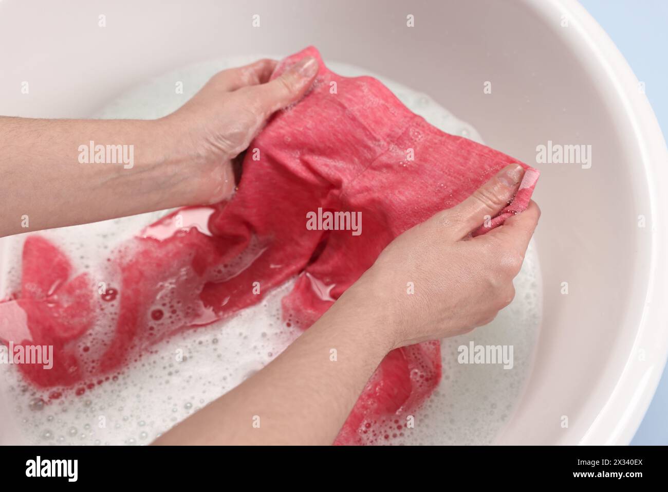 Woman washing baby clothes in basin, closeup Stock Photo