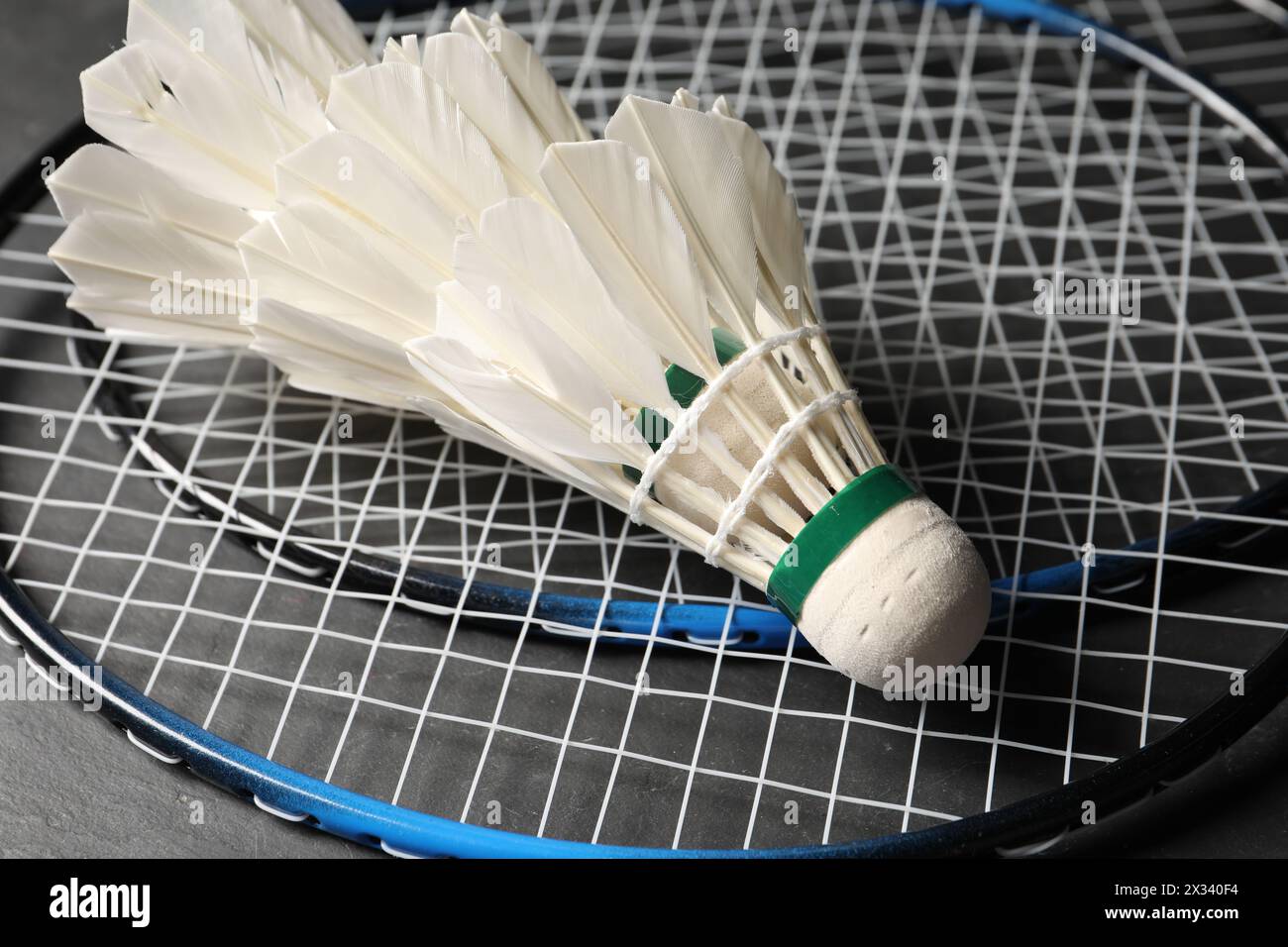 Feather badminton shuttlecocks and rackets on grey background, closeup Stock Photo