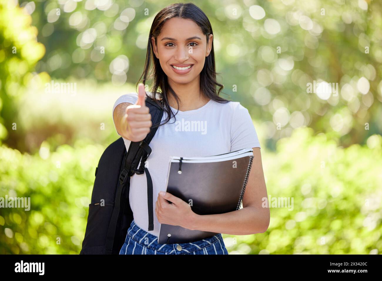 Students with thumbs up with books hi-res stock photography and images ...