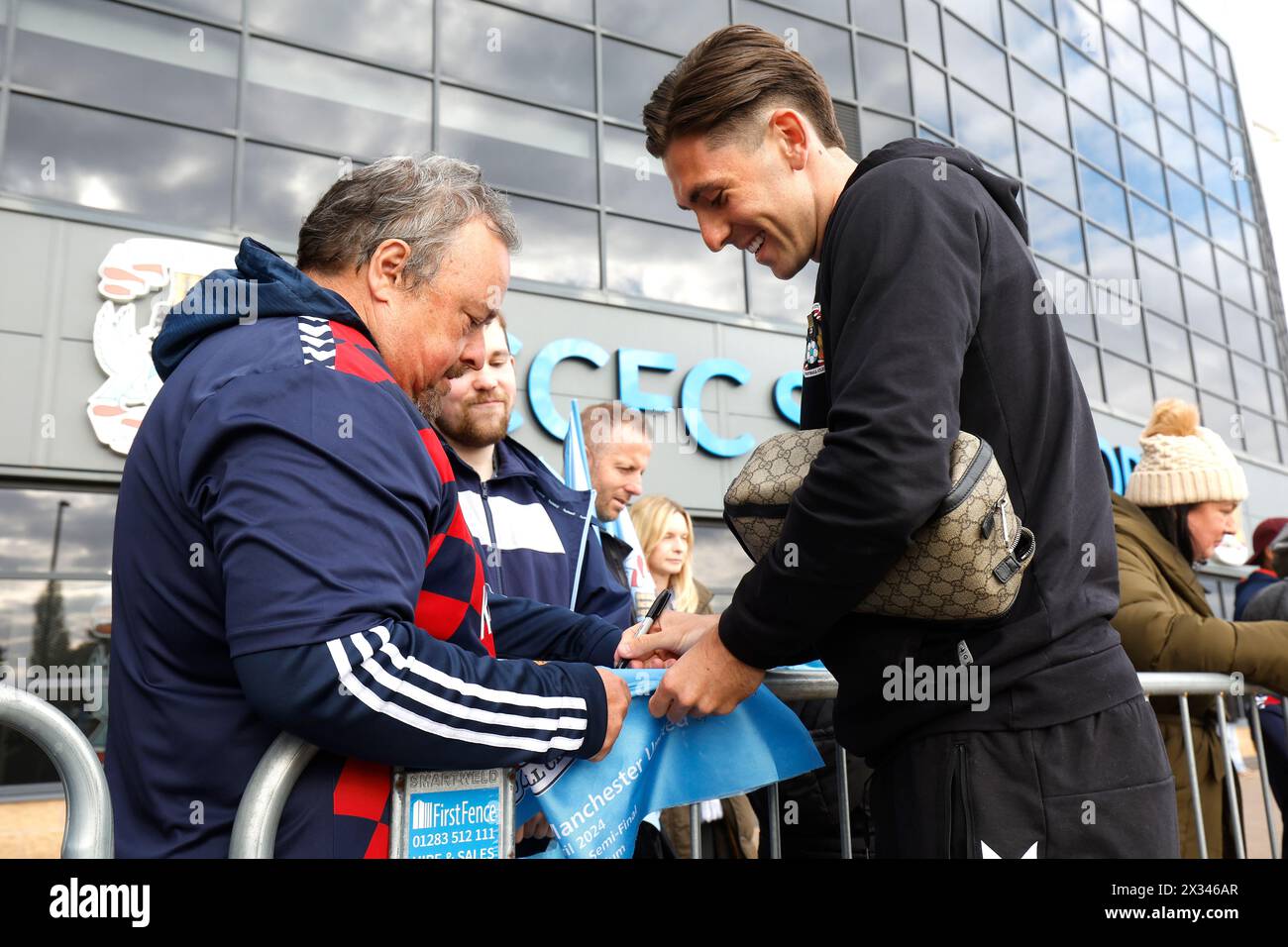 Coventry City's Luis Binks signs autographs ahead of the Sky Bet Championship match at Coventry Building Society Arena, Coventry. Picture date: Wednesday April 24, 2024. Stock Photo