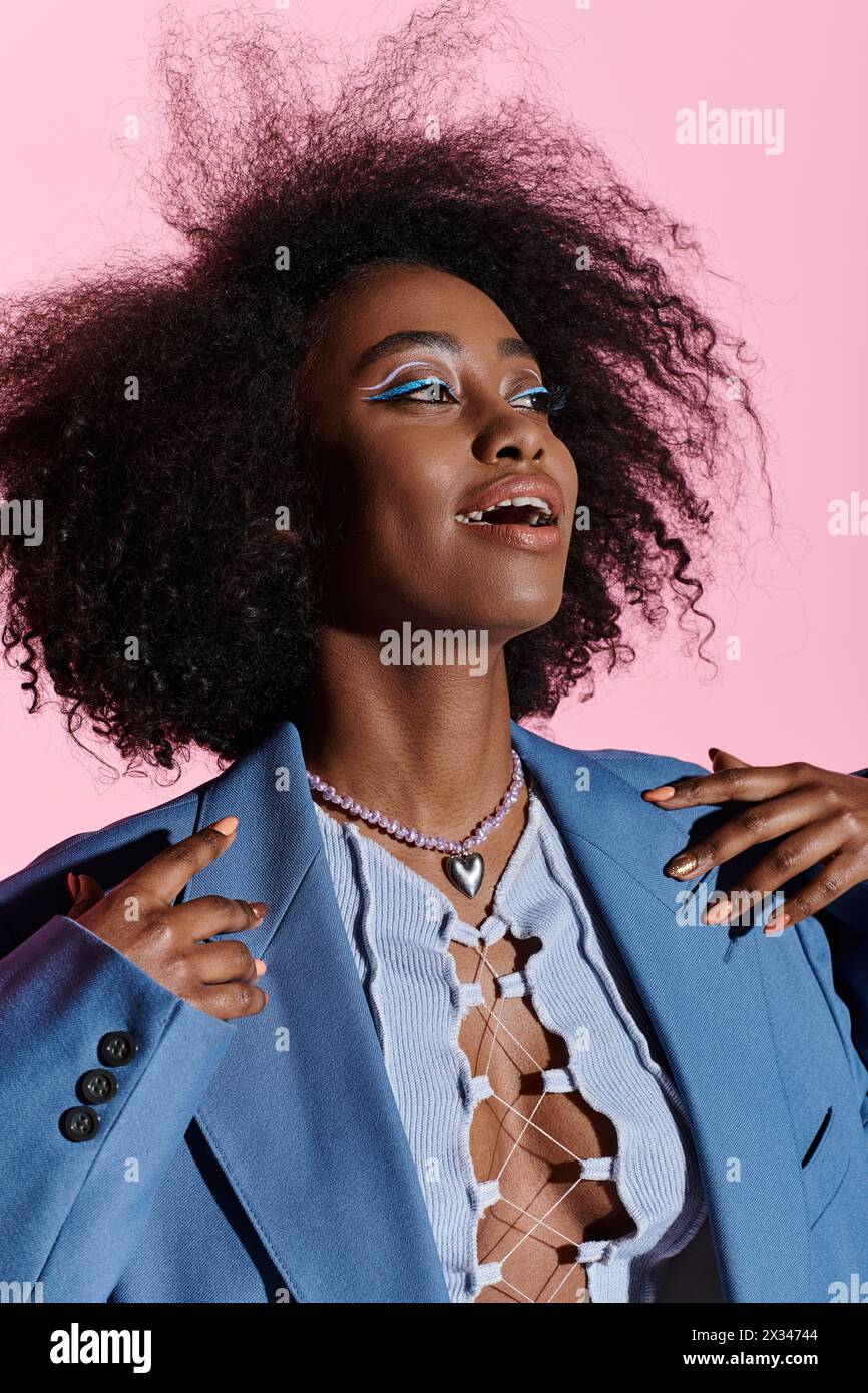 Stylish young African American woman with curly hair wearing a blue ...