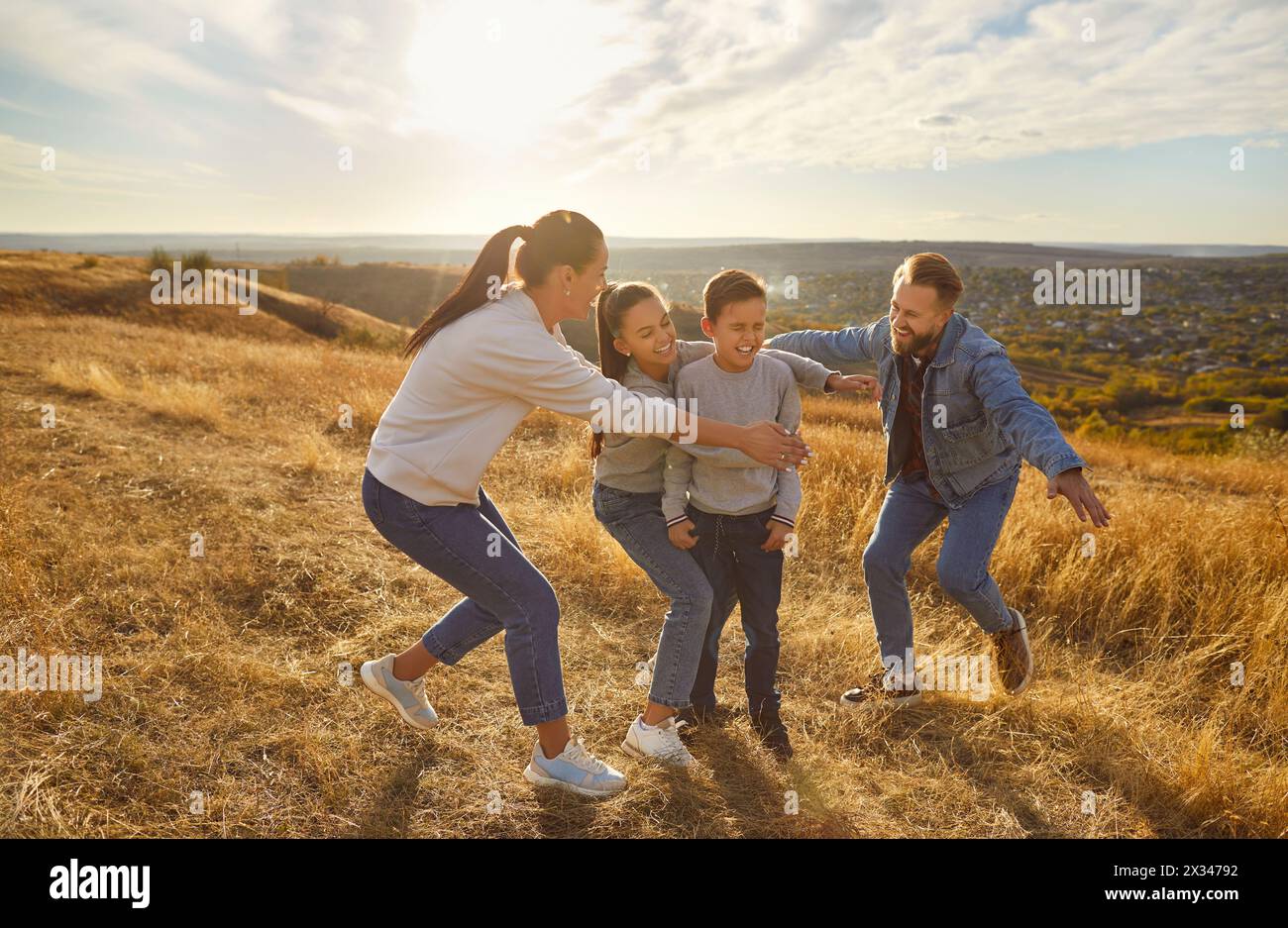 Happy playful family nature outdoor rest, spending weekend holiday together, parents, children Stock Photo