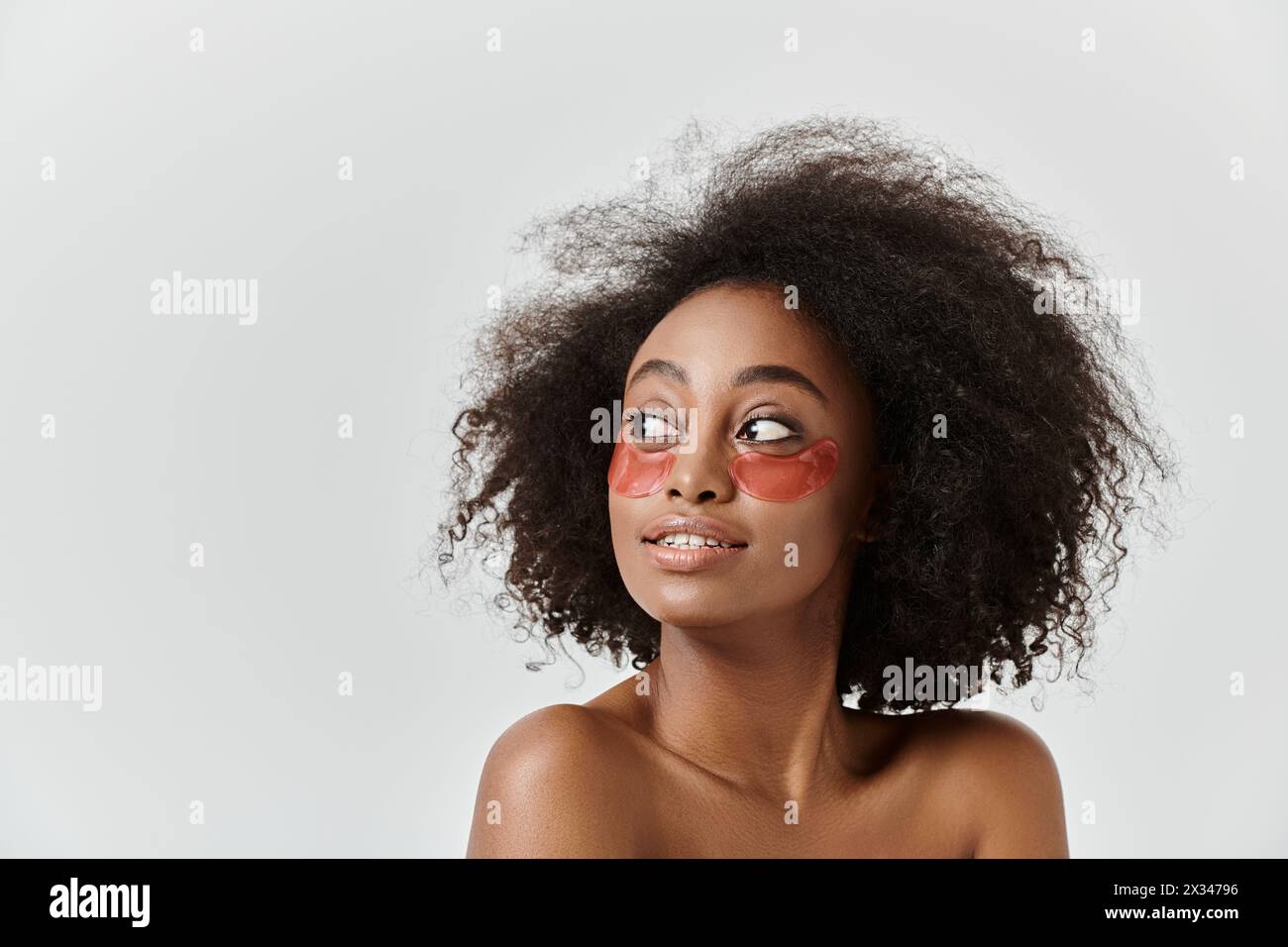 A beautiful young African American woman with curly hair, showcasing ...