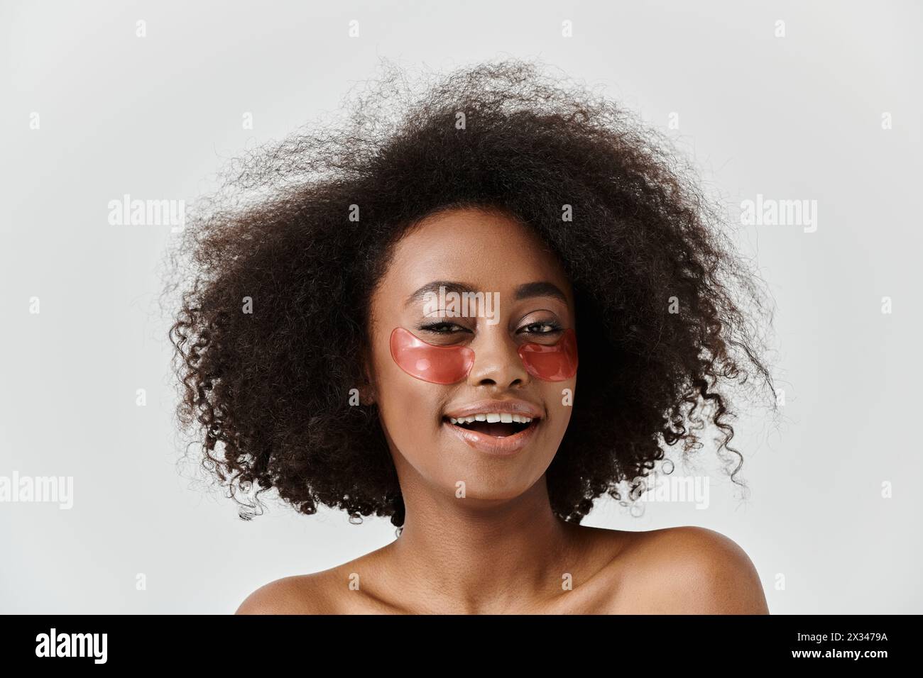 A beautiful young African American woman with curly hair showcasing eye ...