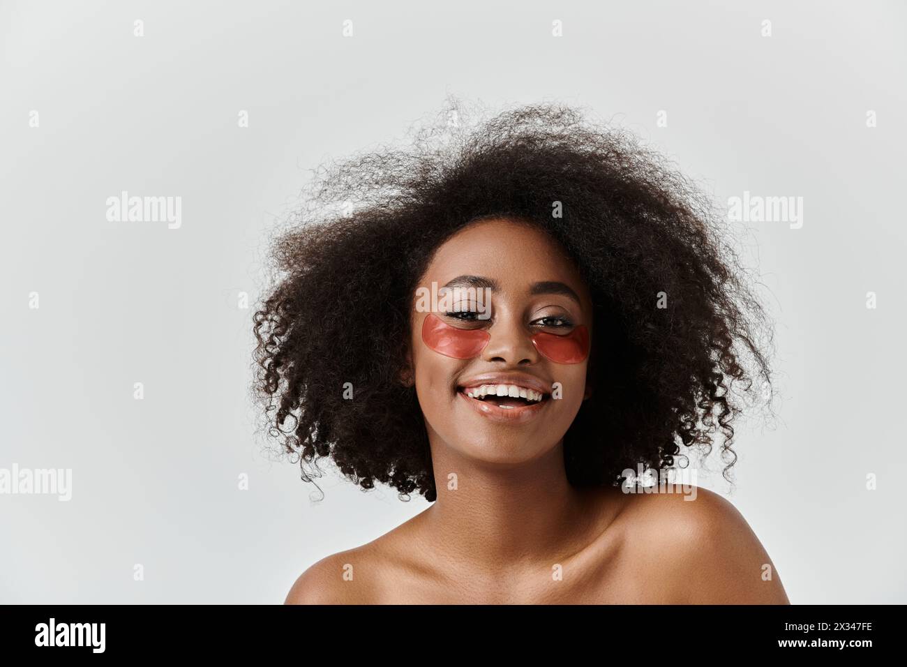 A beautiful young African American woman with curly hair showcasing ...