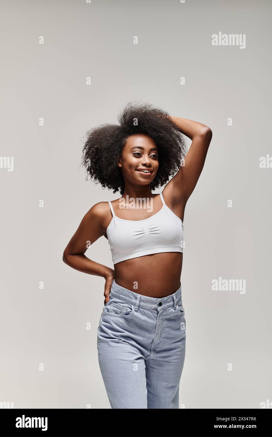 A stunning young African American woman with curly hair poses ...