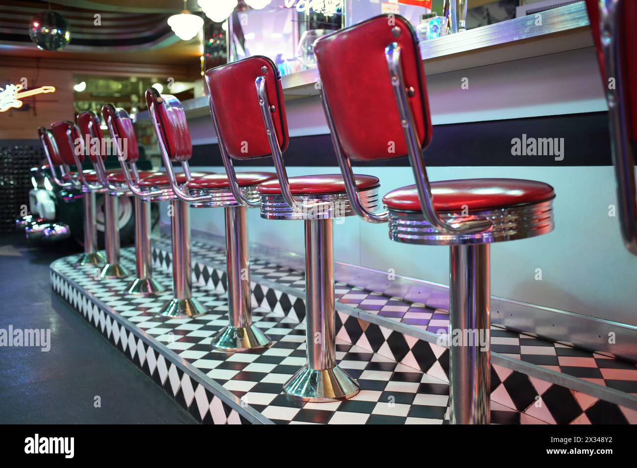 MOSCOW - JAN 21, 2015: Row of red chairs near bar counter at the American restaurant Beverly Hills Diner Stock Photo