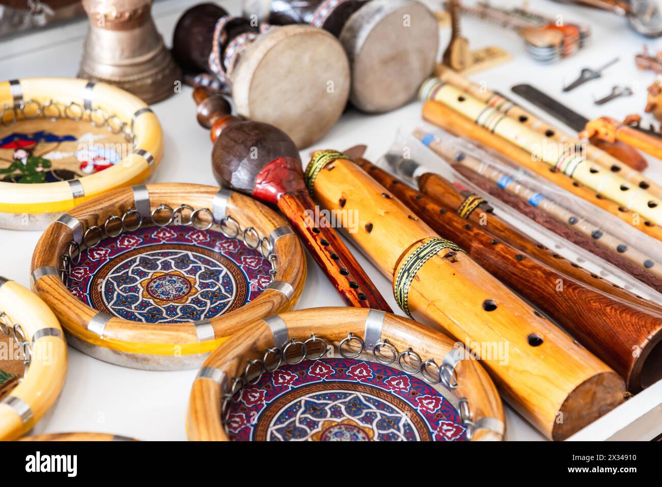 Central Asian percussion and wind musical instruments are put up for sale at a bazaar in Bukhara, close up photo with selective soft focus Stock Photo